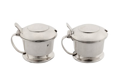 Lot 306 - A pair of George V ' Arts and Crafts' mustard pots, Birmingham 1914 by Liberty and Co