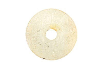 Lot 127 - A CHINESE PALE-CELADON JADE ARCHAISTIC DISC, BI