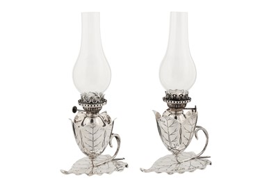 Lot 381 - A pair of Victorian sterling silver oil lamp chambersticks, Birmingham 1892 by Hukin and Heath, one marked for Samuel Smith