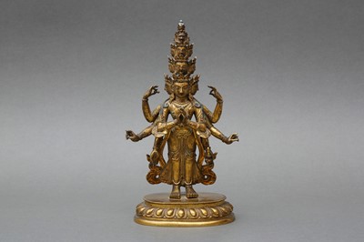 Lot 181 - A SINO-TIBETAN GILT-BRONZE FIGURE OF ELEVEN-HEADED EKADASAMUKHA AVALOKITESHVARA
