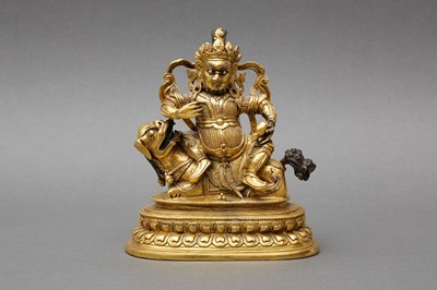 Lot 179 - A SINO-TIBETAN GILT-BRONZE FIGURE OF VAISHRAVANA