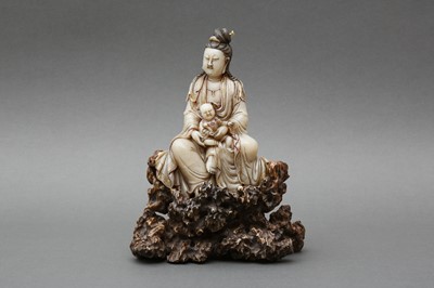 Lot 635 - A LARGE CHINESE SOAPSTONE FIGURE OF GUANYIN AND CHILD