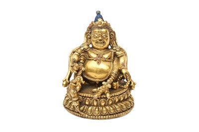 Lot 578 - A FINE TIBETAN GILT-BRONZE SMALL FIGURE OF KUBERA