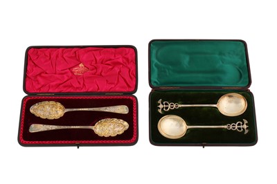 Lot 142 - A cased pair of Victorian sterling silver fruit serving spoons, London 1895 by Daniel and John Welby overstriking another