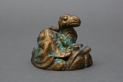 Lot 163 - A CHINESE GILT BRONZE 'QILIN' MAT WEIGHT