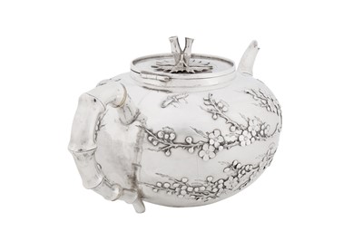 Lot 123 - A late 19th / early 20th century Chinese export silver three-piece tea service, Canton circa 1900, marked Ye Bo, retailed by Wang Hing
