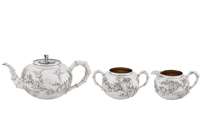 Lot 123 - A late 19th / early 20th century Chinese export silver three-piece tea service, Canton circa 1900, marked Ye Bo, retailed by Wang Hing