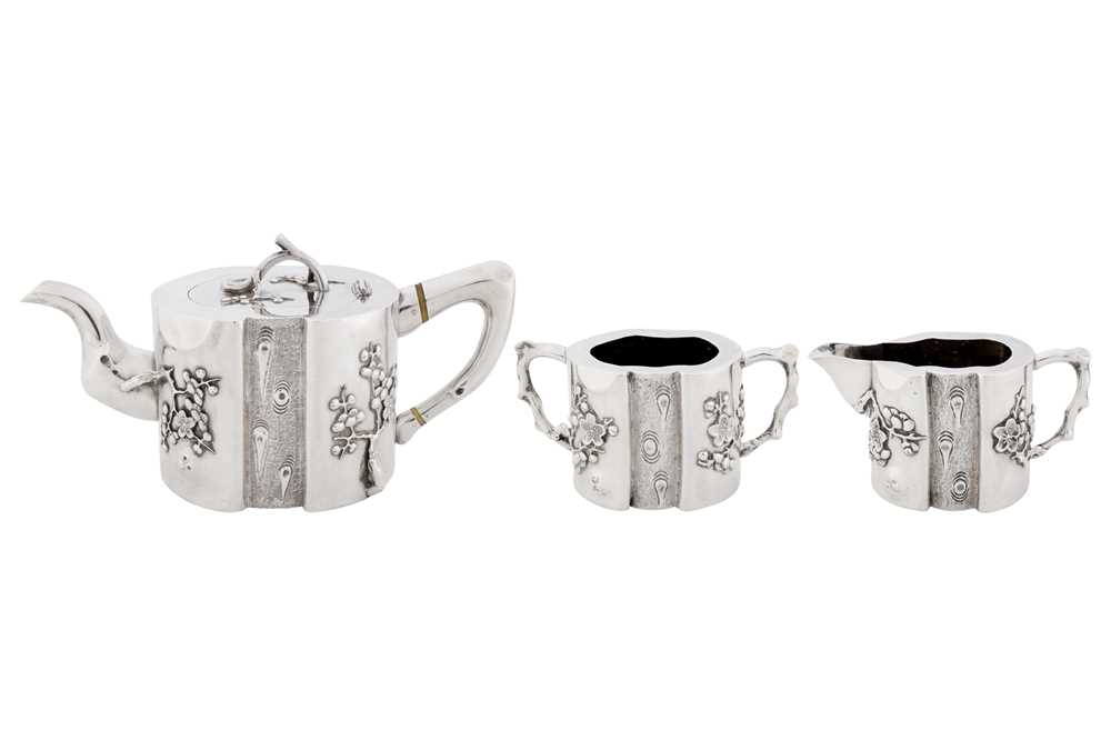 Lot 102 - A late 19th / early 20th century Chinese export silver three-piece tea service, Canton or Shanghai circa 1900, marked Qi Xiang, retailed by Pao Kuang of Hong Kong