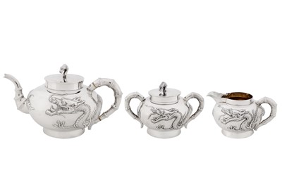 Lot 10 - An early 20th century Chinese export silver three-piece tea service, Shanghai or Hong Kong circa 1920, marked Yan, retailed by Po Cheng of Hong Kong