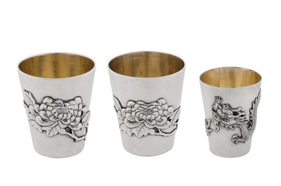 Lot 59 - A pair of early 20th century Chinese export silver tots or small beakers, Canton circa 1910, marked Zhuo, retailed by Wo Kwong of Hong Kong