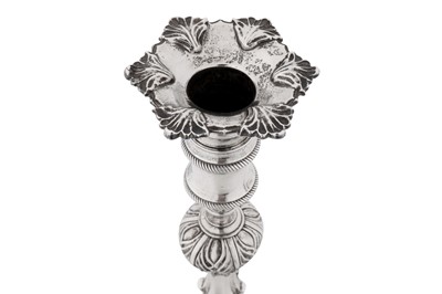 Lot 570 - A set of four George III sterling silver candlesticks, London 1765 by Ebenezer Coker