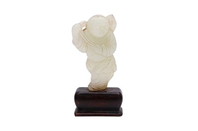 Lot 52 - A CHINESE PALE-CELADON JADE 'BOY AND LOTUS' CARVING