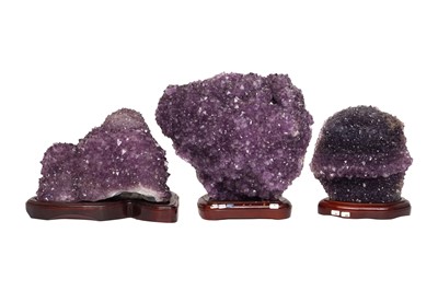 Lot 70 - THREE AMETHYST GEODE CLUSTERS ON STANDS