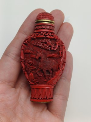 Lot 77 - A CHINESE CINNABAR LACQUER 'HORSES' SNUFF BOTTLE