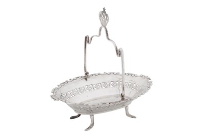 Lot 305 - An early 20th century Iraqi unmarked silver swing handled basket, Baghdad circa 1930