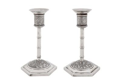 Lot 262 - A pair of early 20th century Chinese export silver candlesticks, Shanghai circa 1920, marked Bi Ji, retailed by Wang Hing of Canton and Hong Kong
