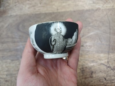 Lot 49 - A RARE CHINESE EN-GRISAILLE 'IGNATIUS OF LOYOLA' CUP AND SAUCER