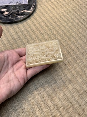 Lot 58 - A CHINESE CARVED CELADON JADE 'DRAGON' PLAQUE