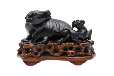 Lot 90 - A CHINESE ZITAN HARDWOOD 'BUFFALO AND QILIN' CARVING