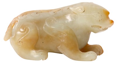 Lot 608 - A CHINESE CELADON AND RUSSET JADE 'BIXIE' CARVING