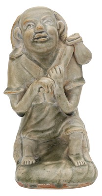 Lot 123 - A CHINESE CELADON-GLAZED FIGURE OF A FOREIGNER