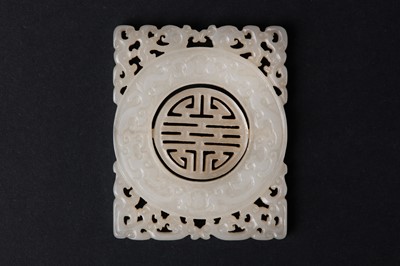 Lot 63 - A CHINESE PALE CELADON JADE RETICULATED 'SHOU' PLAQUE