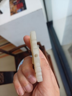 Lot 63 - A CHINESE PALE CELADON JADE RETICULATED 'SHOU' PLAQUE