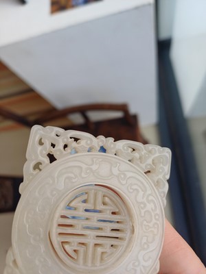 Lot 63 - A CHINESE PALE CELADON JADE RETICULATED 'SHOU' PLAQUE