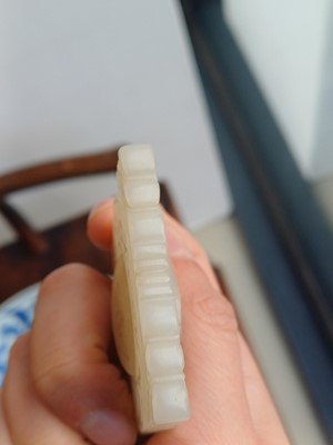 Lot 63 - A CHINESE PALE CELADON JADE RETICULATED 'SHOU' PLAQUE