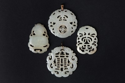 Lot 77 - A GROUP OF FOUR CARVED JADE PENDANTS