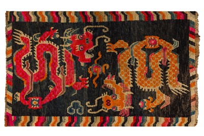 Lot 52 - AN ANTIQUE TIBETAN RUG