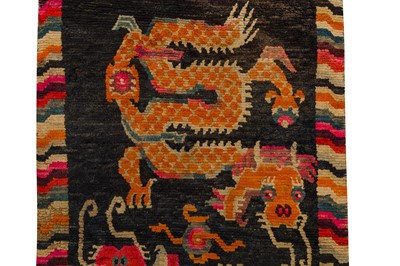Lot 52 - AN ANTIQUE TIBETAN RUG