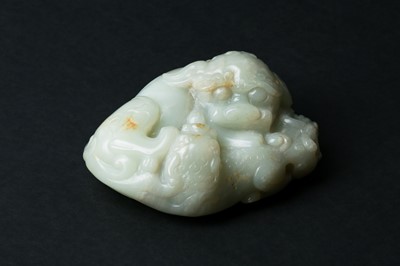 Lot 65 - A CHINESE PALE CELADON JADE 'BUDDHIST LIONS' CARVING