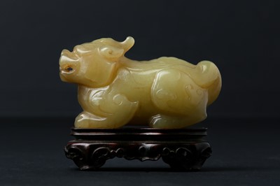Lot 62 - A CHINESE YELLOW JADE CARVING OF A MYTHICAL BEAST