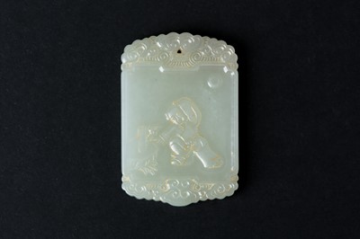 Lot 66 - A CHINESE PALE CELADON JADE 'BOY' PENDANT PLAQUE