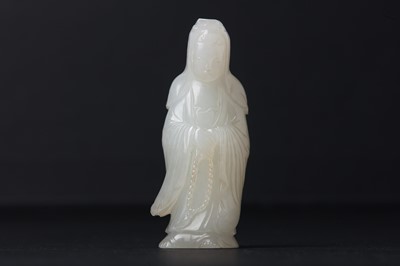 Lot 73 - A CHINESE CELADON JADE CARVING OF GUANYIN