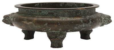 Lot 681 - A CHINESE BRONZE LION-MASK TRIPOD CENSER