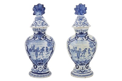 Lot 107 - A MATCHED PAIR OF 19TH CENTURY DELFT VASES AND COVERS