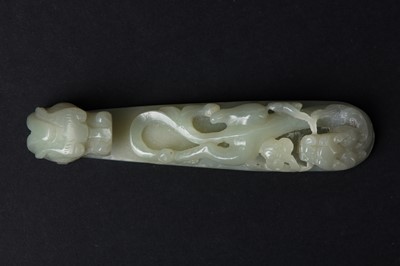 Lot 83 - A CHINESE PALE-CELADON JADE 'DRAGON' BELT HOOK