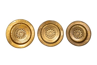 Lot 257 - A GROUP OF THREE NUREMBERG BRASS ALMS DISHES, 16TH CENTURY