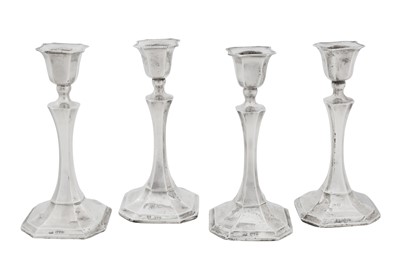 Lot 388 - A set of four George V sterling silver candlesticks, Chester 1931 by Robert Pringle