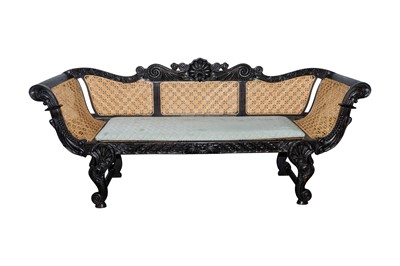 Lot 38 - A first half of the 19th century Ceylon (Sri Lanka) carved and caned ebony sofa