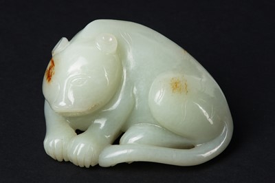 Lot 64 - A CHINESE CELADON AND RUSSET JADE 'TIGER' CARVING