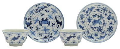 Lot 514 - A PAIR OF CHINESE BLUE AND WHITE 'CRAB AND FISH' CUPS AND SAUCERS