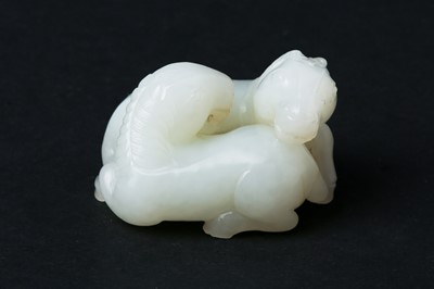 Lot 68 - A FINE CHINESE PALE CELADON JADE 'DOUBLE HORSE' GROUP CARVING