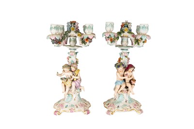 Lot 223 - A PAIR OF EARLY 20TH CENTURY DRESDEN FIGURAL FOUR BRANCH CANDELABRA