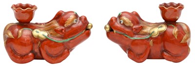 Lot 577 - A PAIR OF CHINESE CORAL-GLAZED 'BUDDHIST LION' CANDLE HOLDERS
