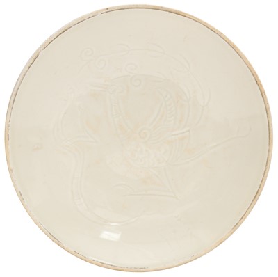 Lot 261 - A Chinese Ding-style white-glazed 'phoenix' dish, 20th century
