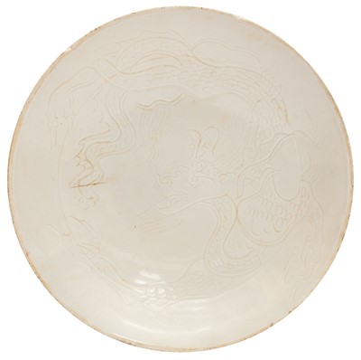 Lot 260 - A Chinese Ding-style white-glazed 'dragon' dish, 20th century