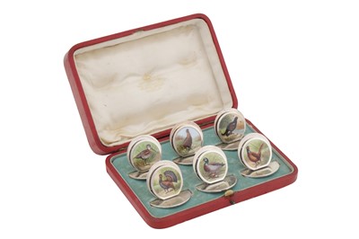 Lot 85 - A cased set of six Edwardian sterling silver and enamel menu holder, Chester 1905 by Sampson Mordan and Co